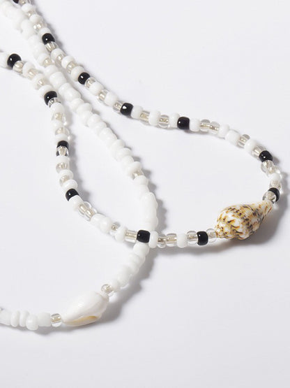 Collier choker perles blanches noires coquillages – Lila