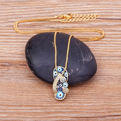 Pendentif tong or strass œil bleu – Léo