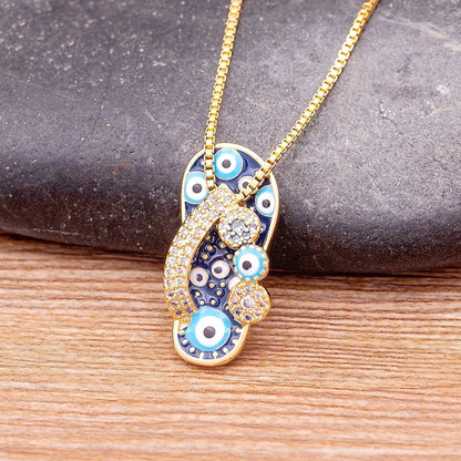 Pendentif tong or strass œil bleu – Léo